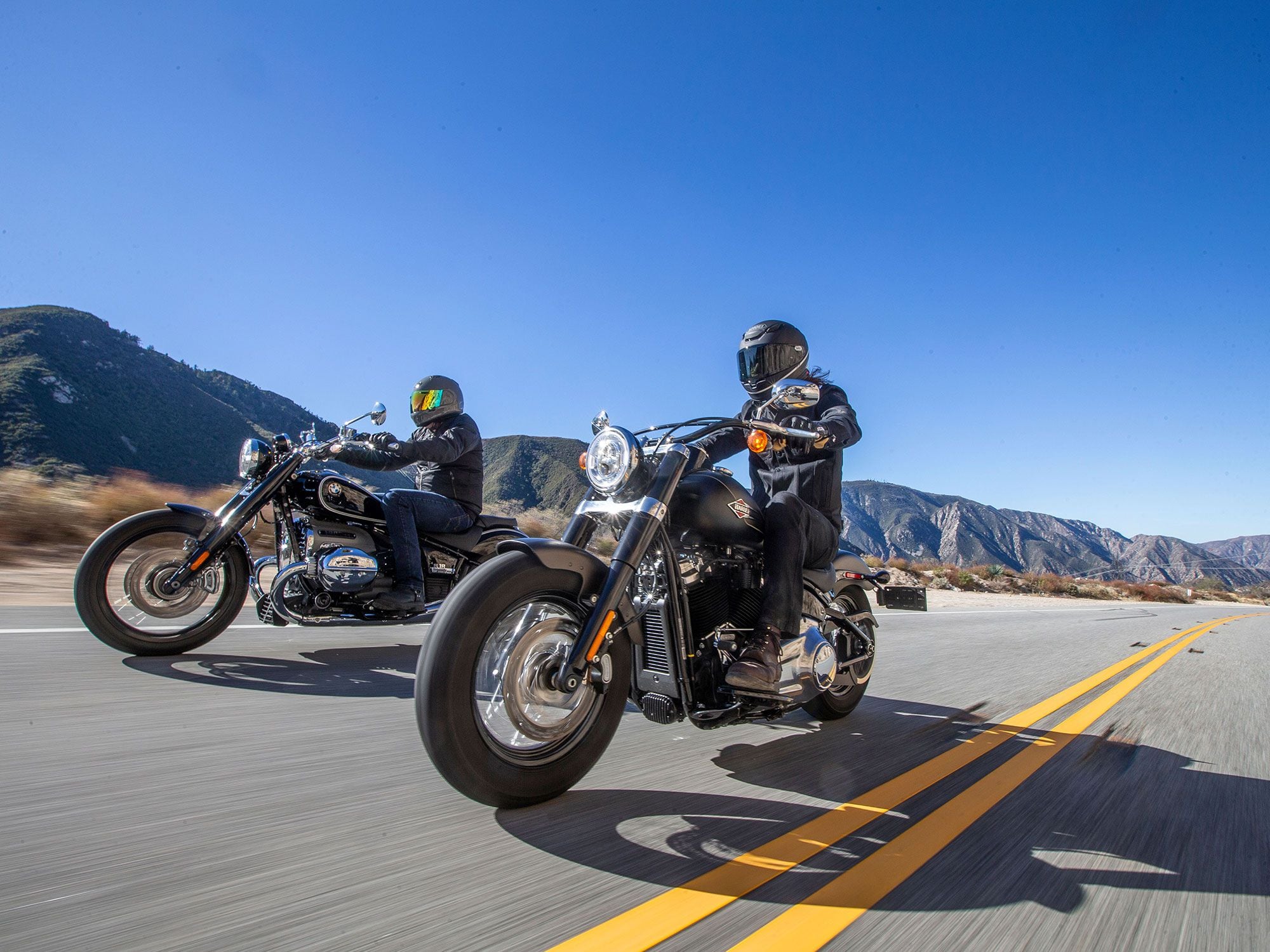 BMW rolls the R 18 cruiser onto American highways. We grab a Harley-Davidson Softail Slim to compare technology, tradition, and culture in two modern heavyweight twins.