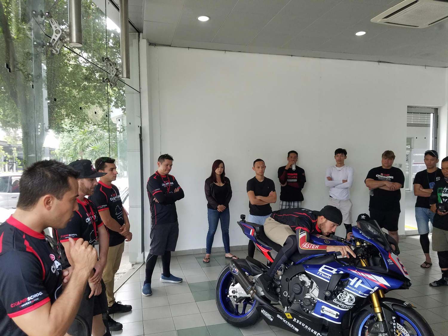 YCRS instructor (and WERA/N2 Endurance national champ) Eziah Davis at our Sepang school discusses and illustrates tucking in while accelerating with his butt preset for the next corner, in this case to the left. Small detail? No, vital technique.