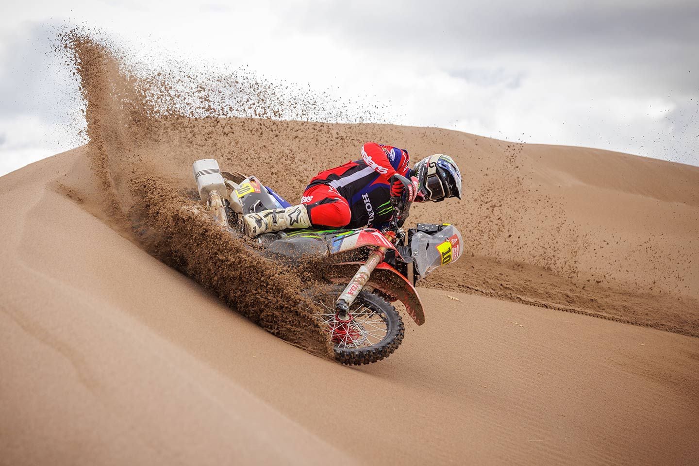 Honda HRC rally racer Skyler Howles sand surfing in the wet dunes.