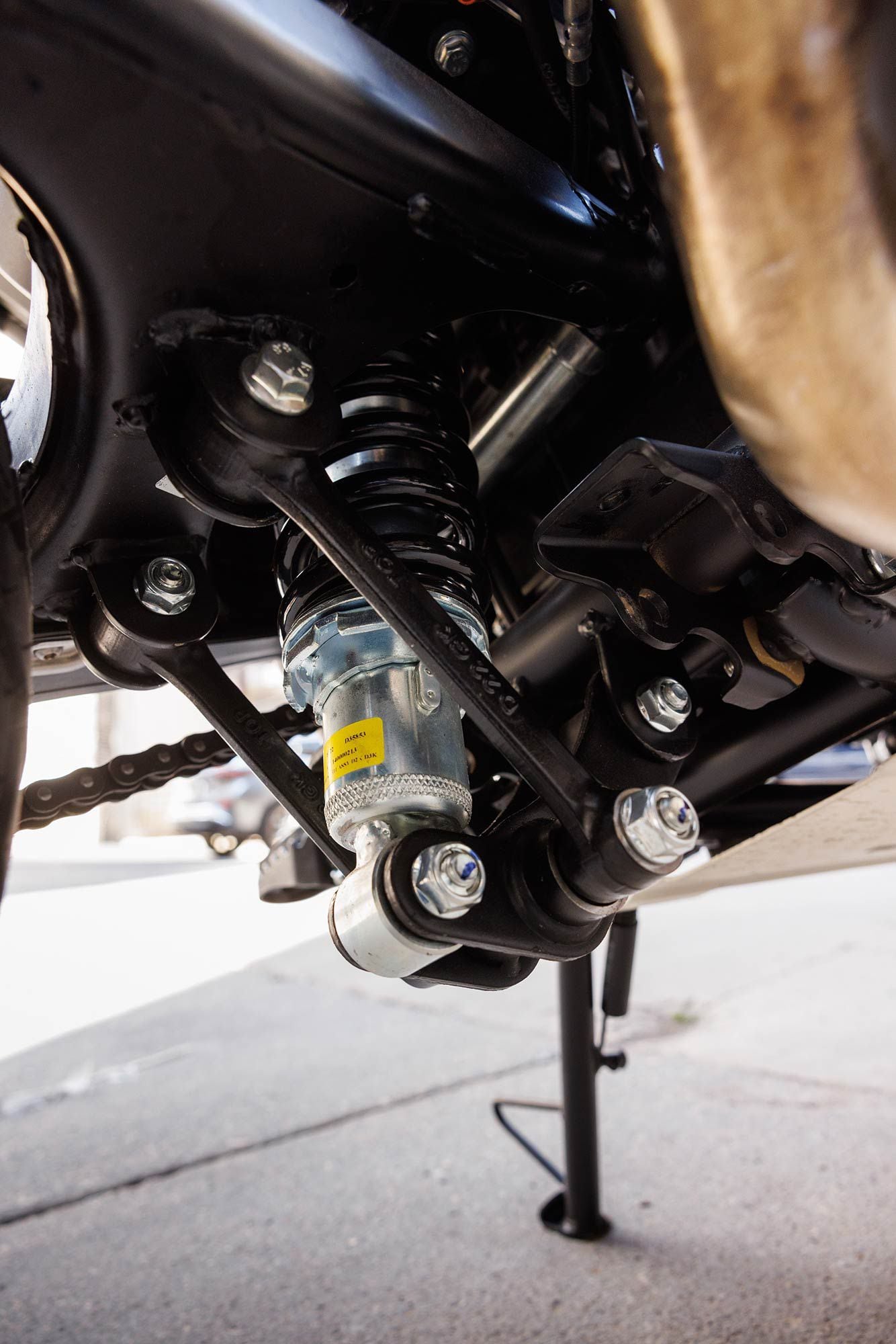 The Scram’s basic rear shock with linkage is adequate for most situations but offers only minimal preload adjustments.