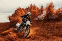 2024 Triumph TF 250-X carving up turn and rooster tailing on dirt track
