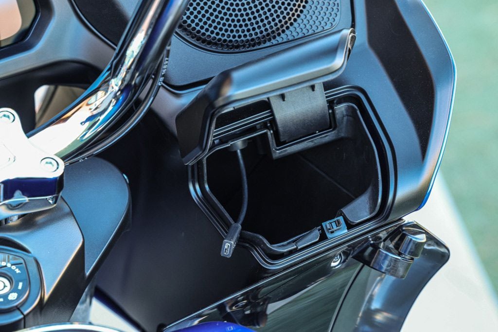 The cubbies on the Road Glide aren't quite as slick and don't allow easy access while in motion, but should you really be messing with your phone while riding?