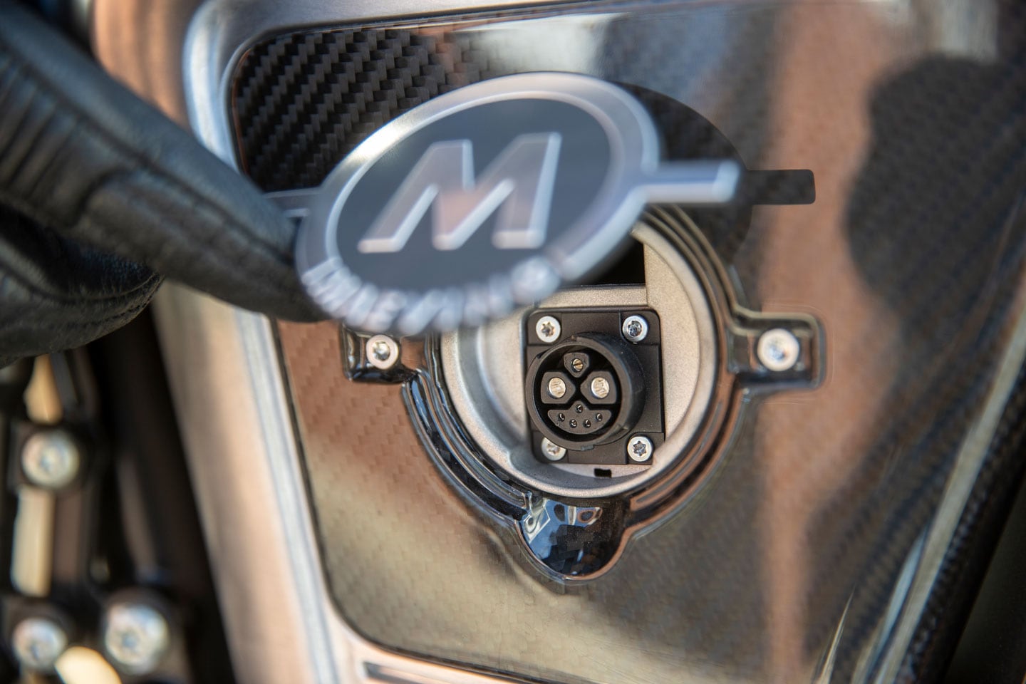 RM1S can be charged with batteries in the bike by plugging directly into this port on the rearward compartment.